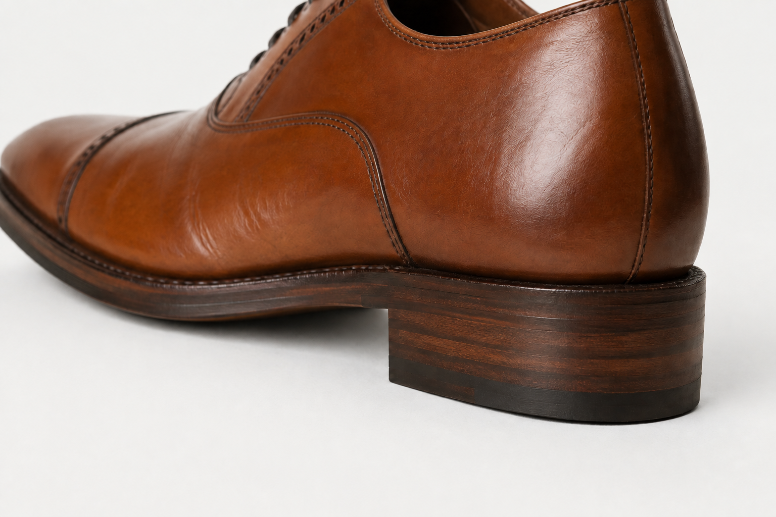 Dress shoe concept showing the leather sole edge, welt and stacked heel detail